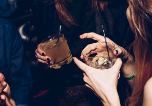 People are enjoying drinks and chatting in a lively atmosphere.