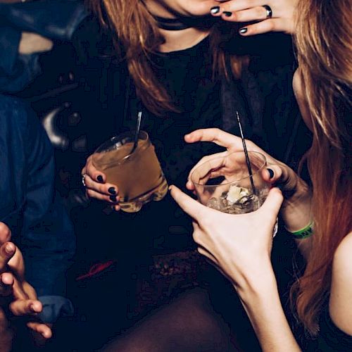 People are enjoying drinks and chatting in a lively atmosphere.