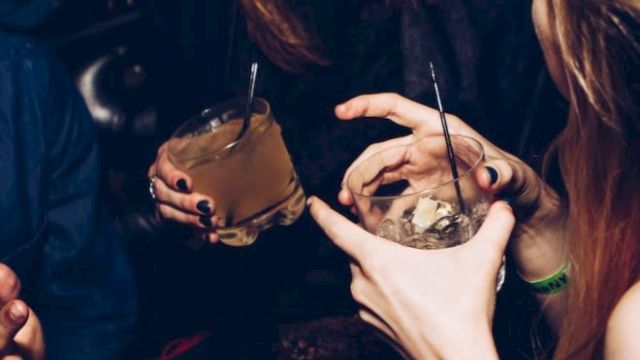 People are enjoying drinks and chatting in a lively atmosphere.